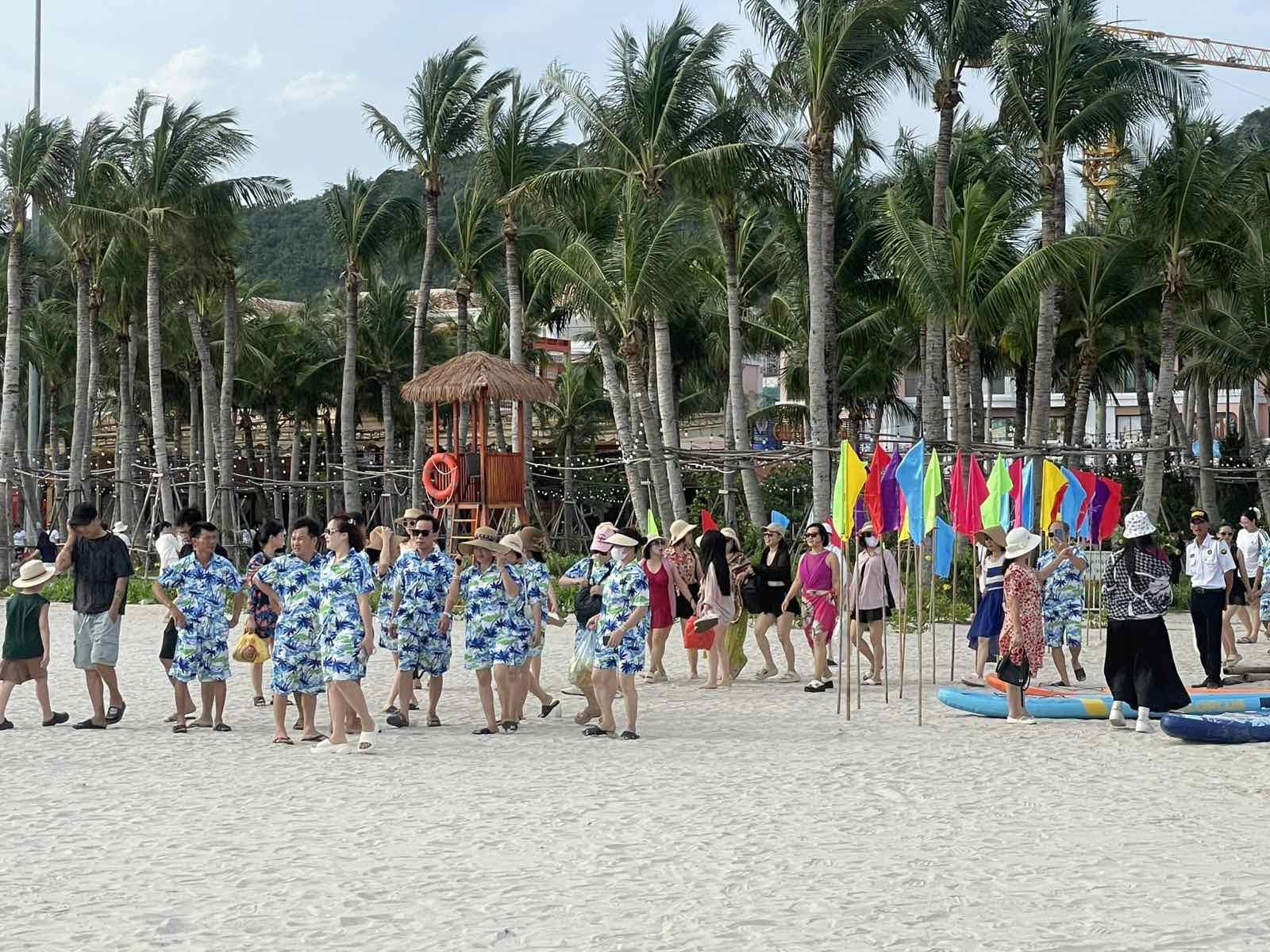 Du khách thư giãn tại bãi tắm Cát Bà với làn nước trong xanh trước khi hòa mình vào lễ hội buổi tối.
