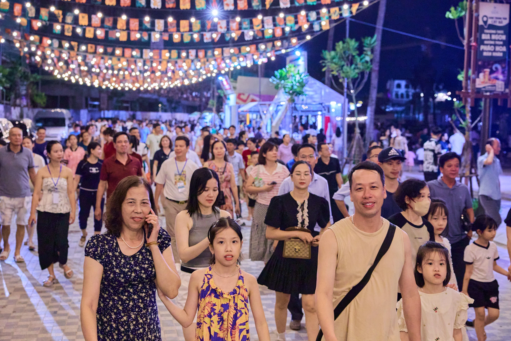 The bustling shopping and entertainment area at VUI-Fest Cat Ba Night Market after dark
