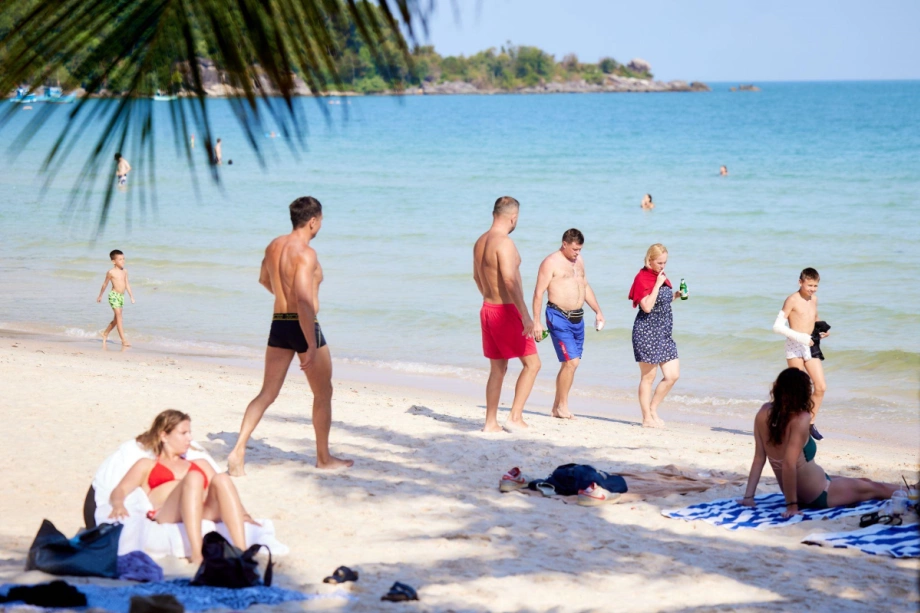 Tourists sunbathe and relax at Kem Beach