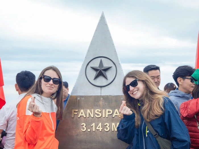 Tourists enjoy taking photos at the 3.143m milestone