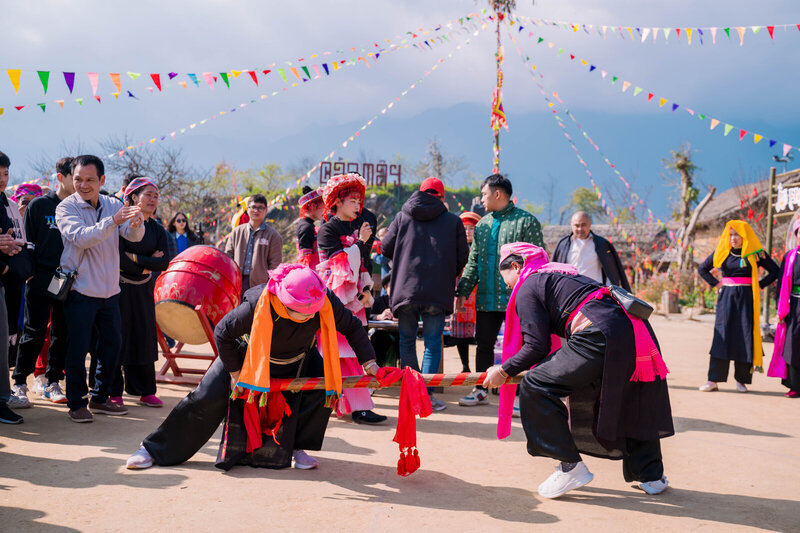 Tourists experience traditional games at May Village