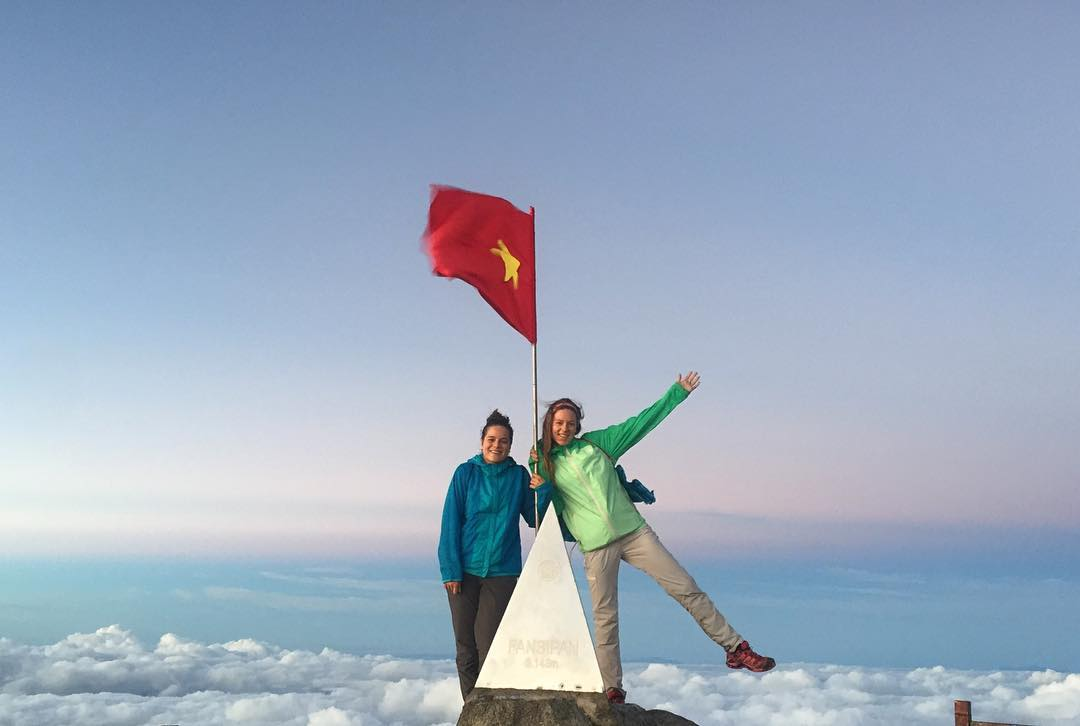 Foreign tourists enjoy checking in at the 3,143m marker on the summit of Fansipan