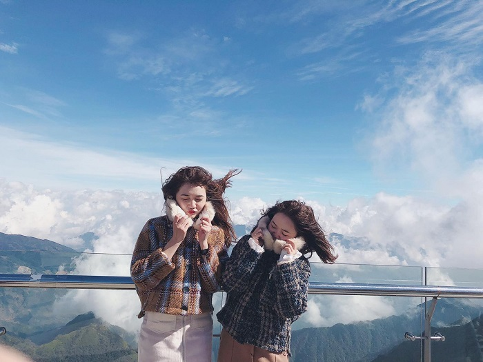 Tourists enjoy the cool air on the summit of Fansipan