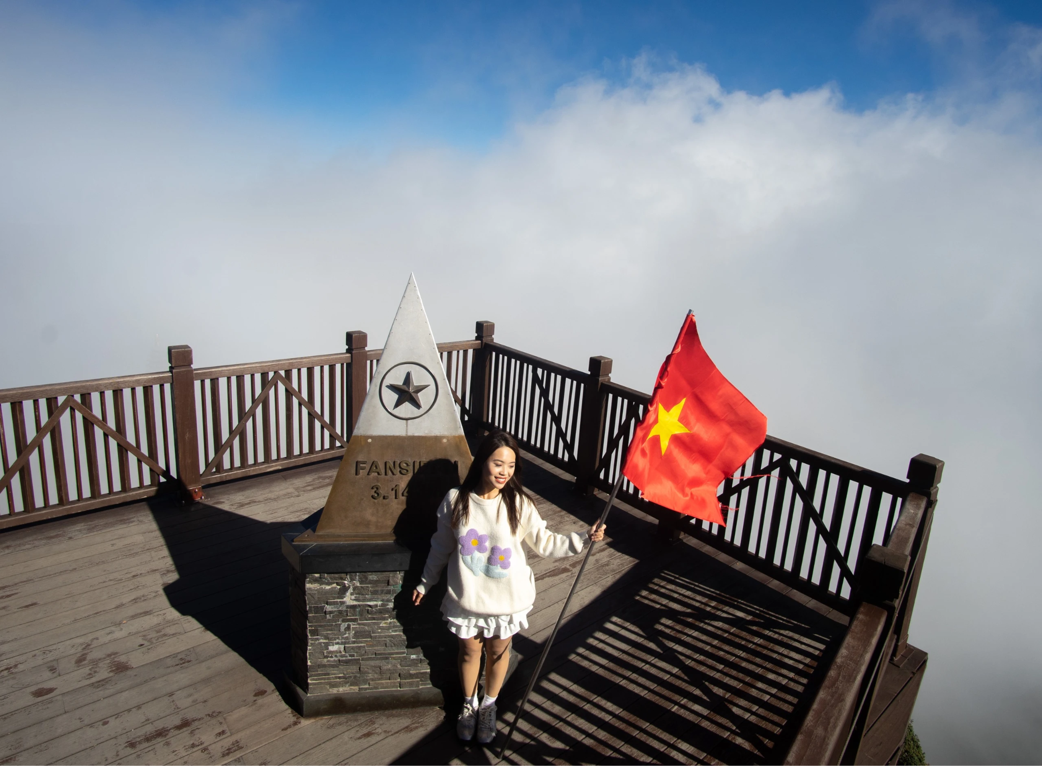 Tourists checking in at the 3,143m landmark on the summit of Fansipan