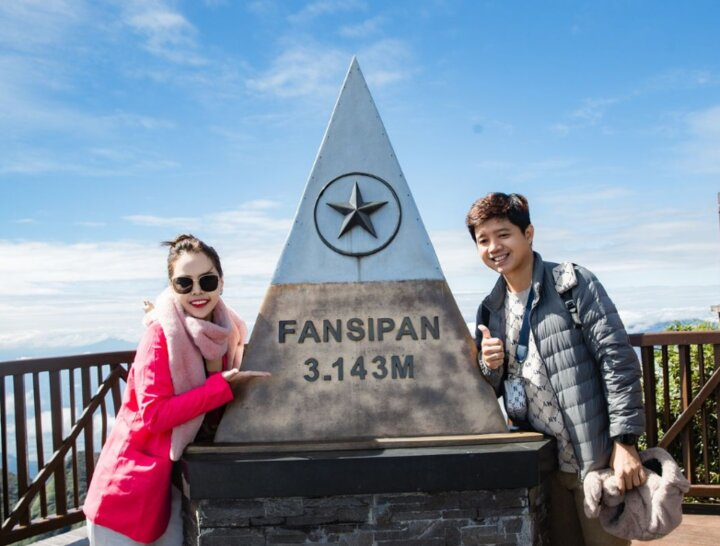 Tourists take memorable photos at the 3,143m landmark