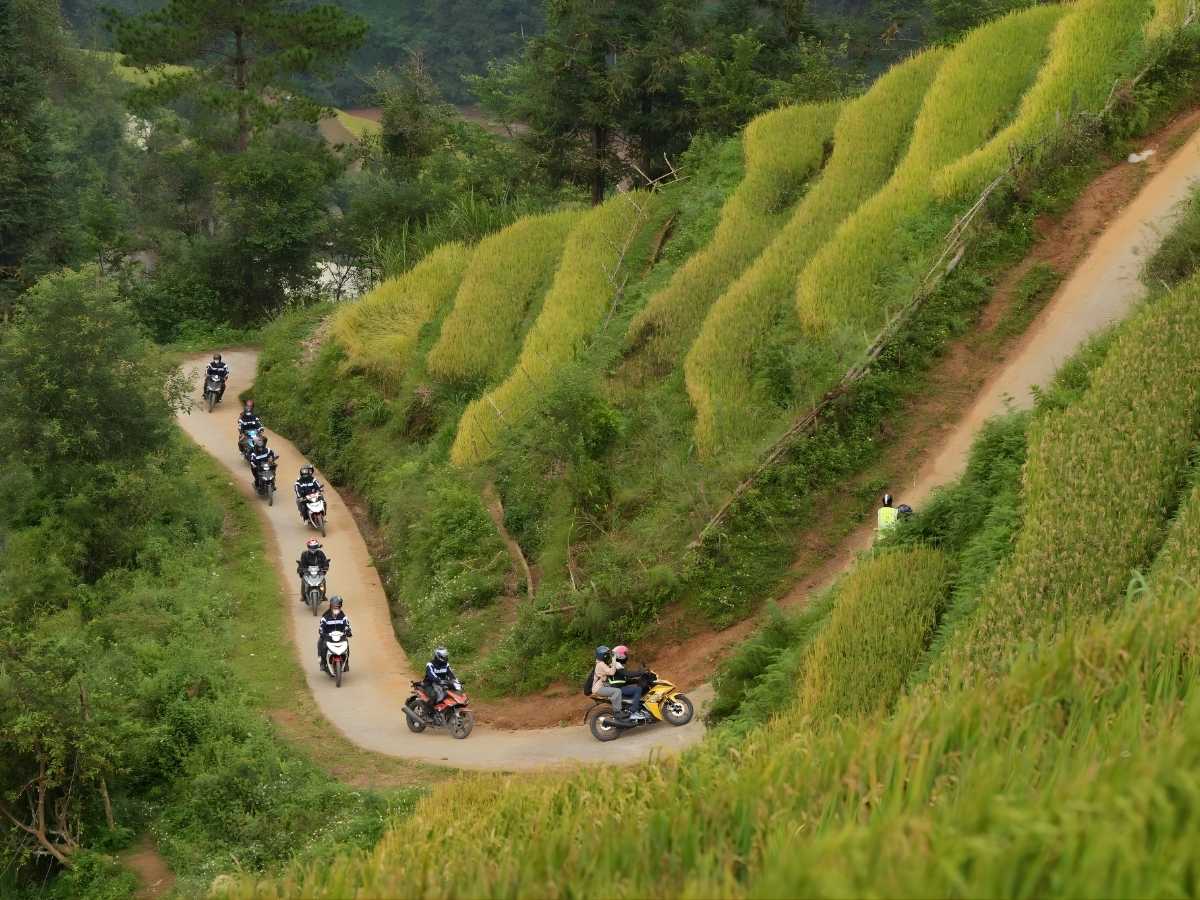 Người lái xe kiểm tra phanh lốp và đèn trước khi chinh phục đèo dốc quanh co Tây Bắc. (Nguồn: Sưu tầm)