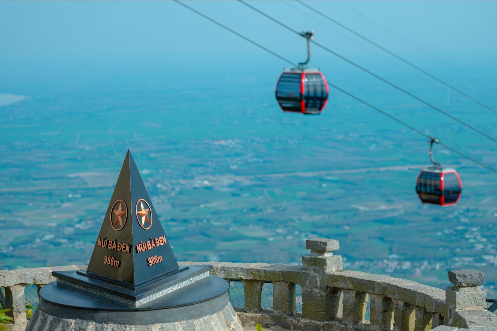 The cable car glides above clouds and valleys on the way to the summit of Ba Den Mountain