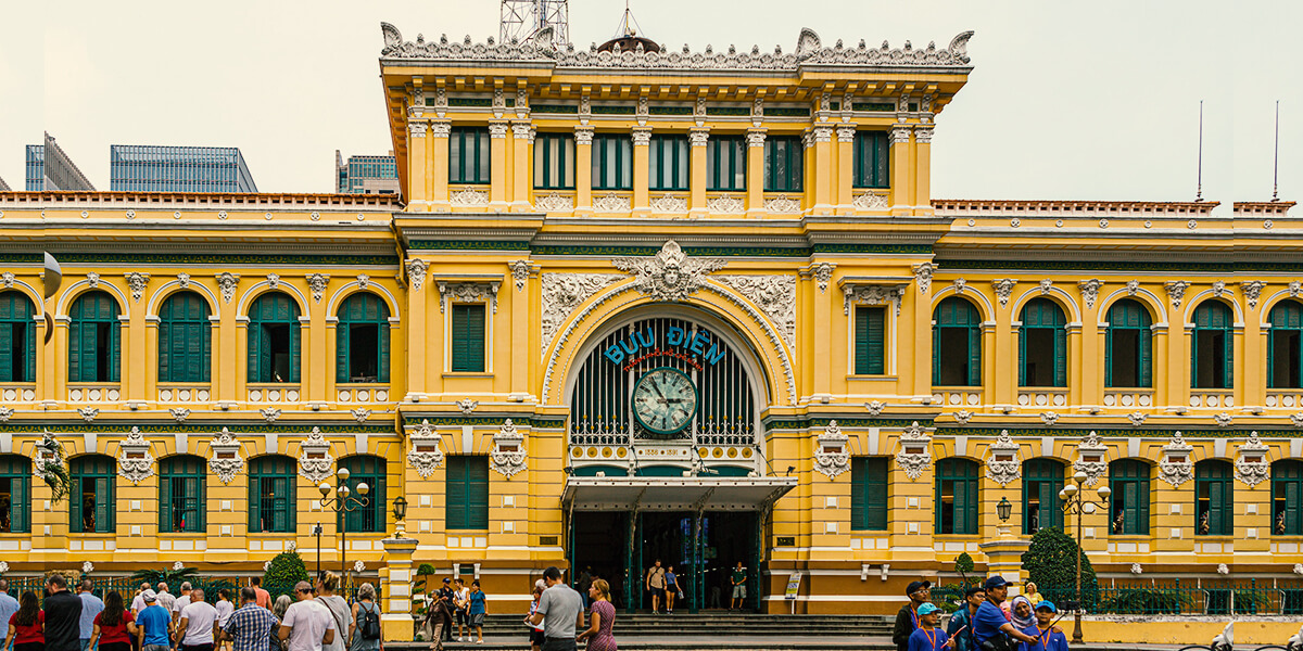 Visitors admire the classic yellow facade of the Central Post Office.