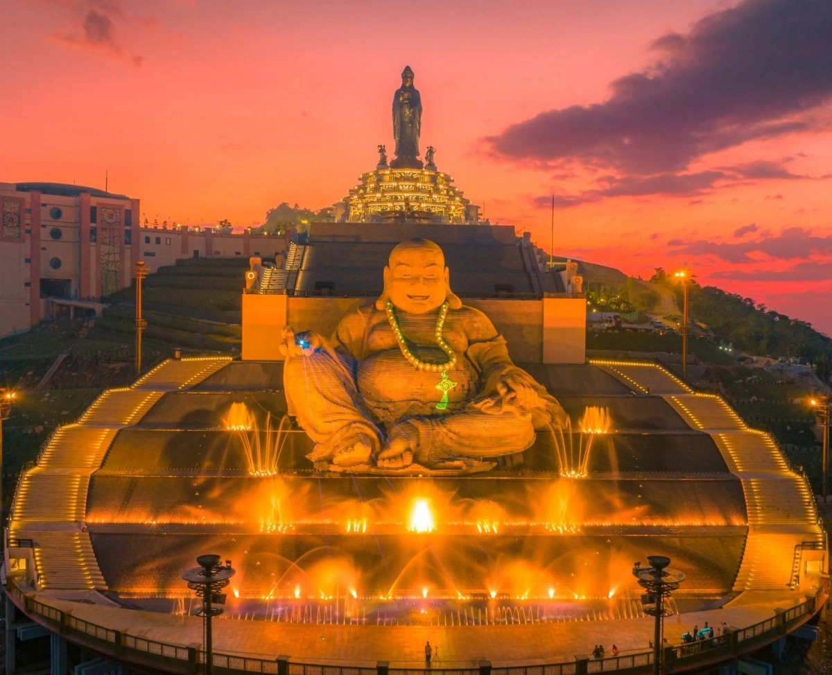 Sunset highlights both the grand Maitreya Bodhisattva and towering Bodhisattva statues