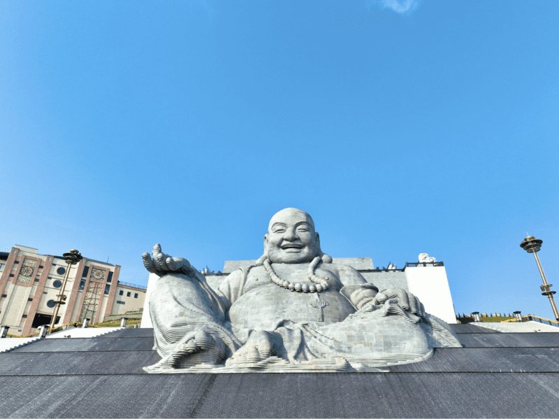 The Maitreya Bodhisattva statue with a gentle smile