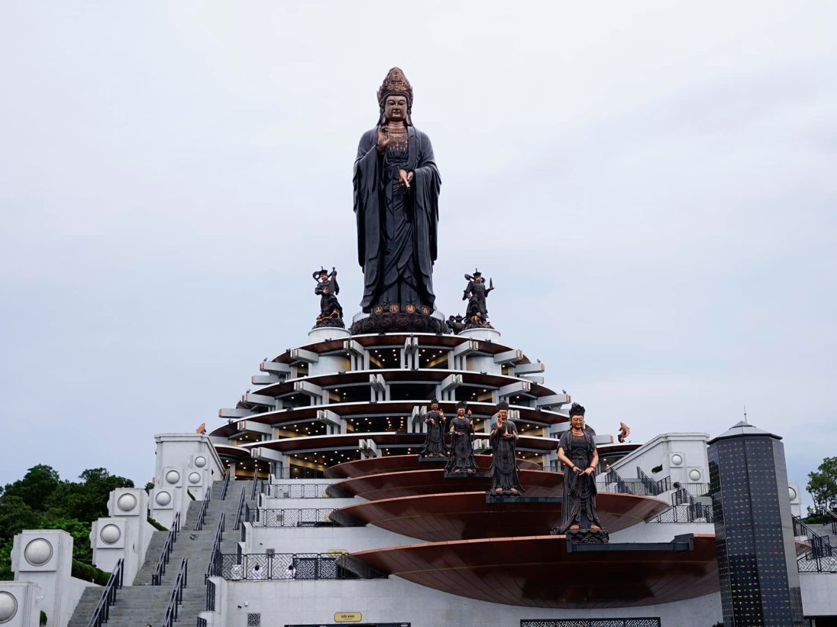 Paying homage to the majestic statue of the Bodhisattva on the summit