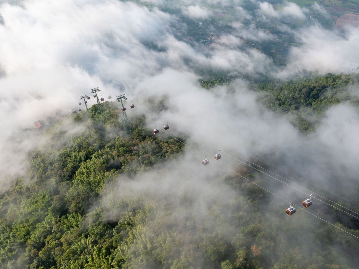 Experience the modern Ba Den cable car soaring through spectacular mountain scenery.