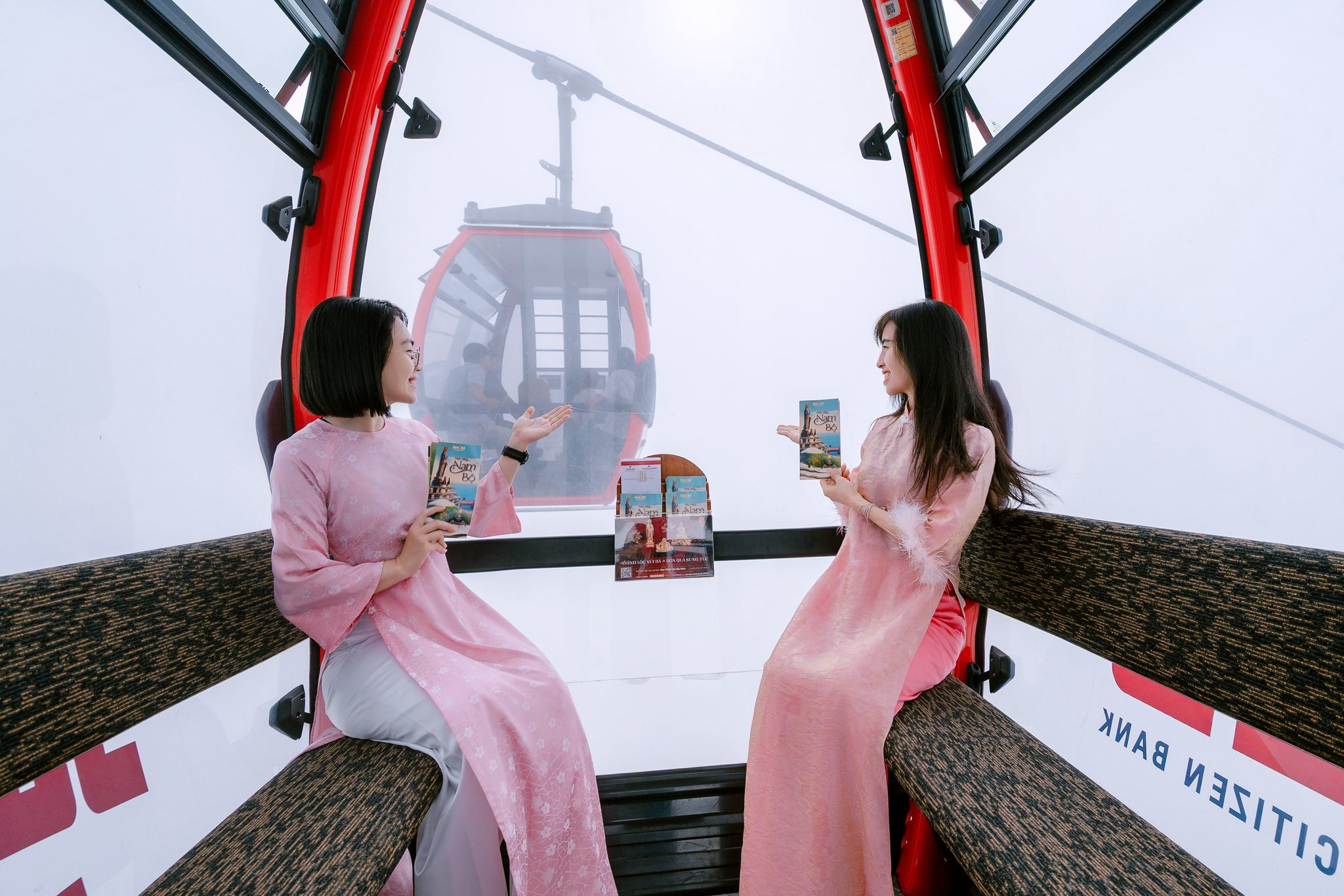 Tourists enjoy the experience of riding the Ba Den Mountain cable car