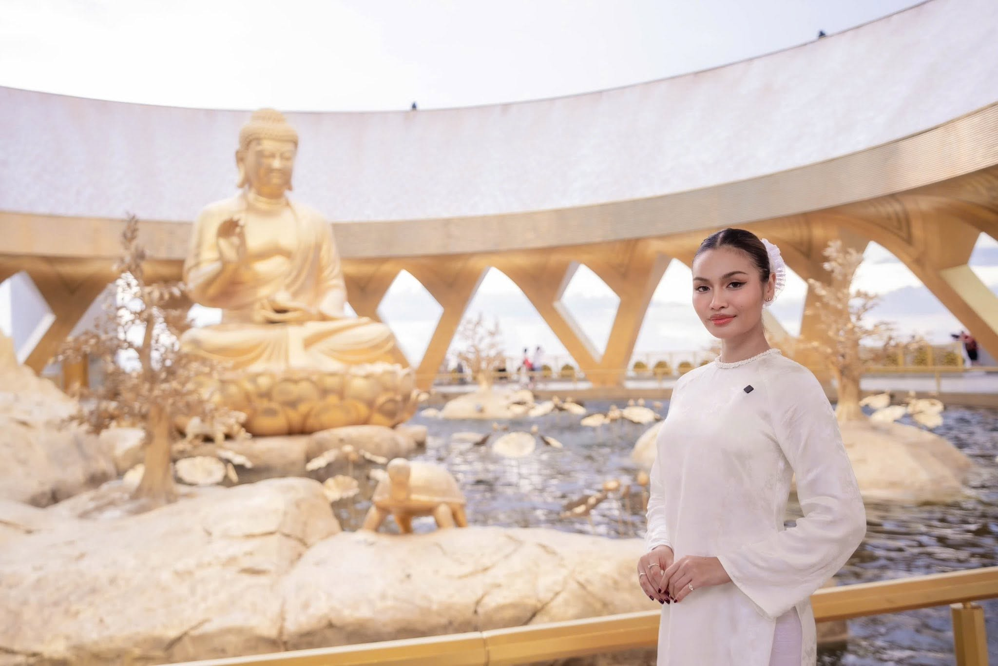 Tourists take photos next to the statue of Konagamana Buddha.