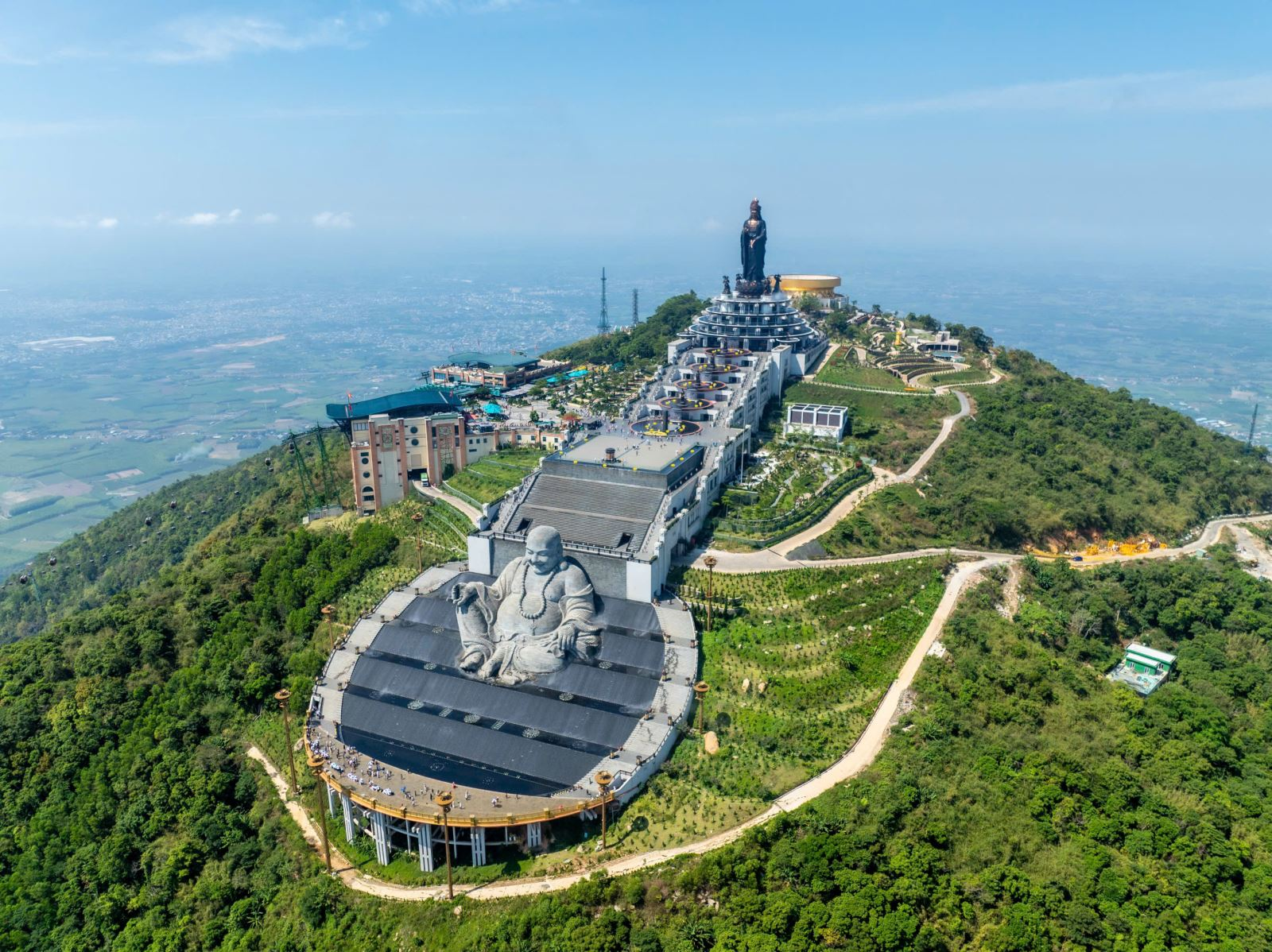 A panoramic view of the iconic spiritual structures on the summit of Ba Den Mountain.