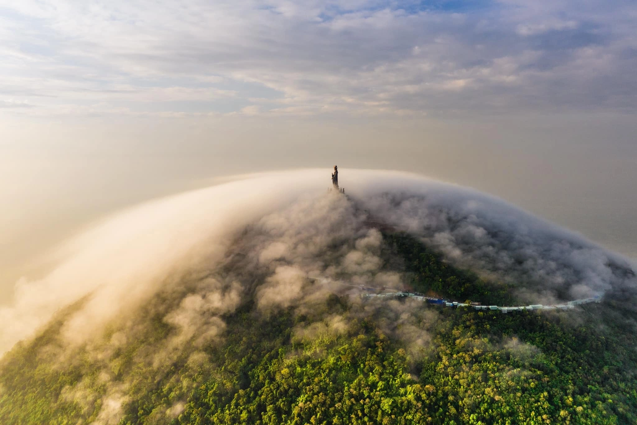 A sea of clouds blankets the summit of Ba Den Mountain